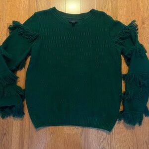 Dark green knit sweater with feathered sleeve detail.